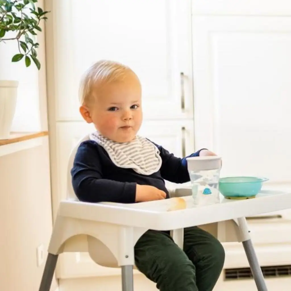 Baby wartet im Hochstuhl auf seine Beikost